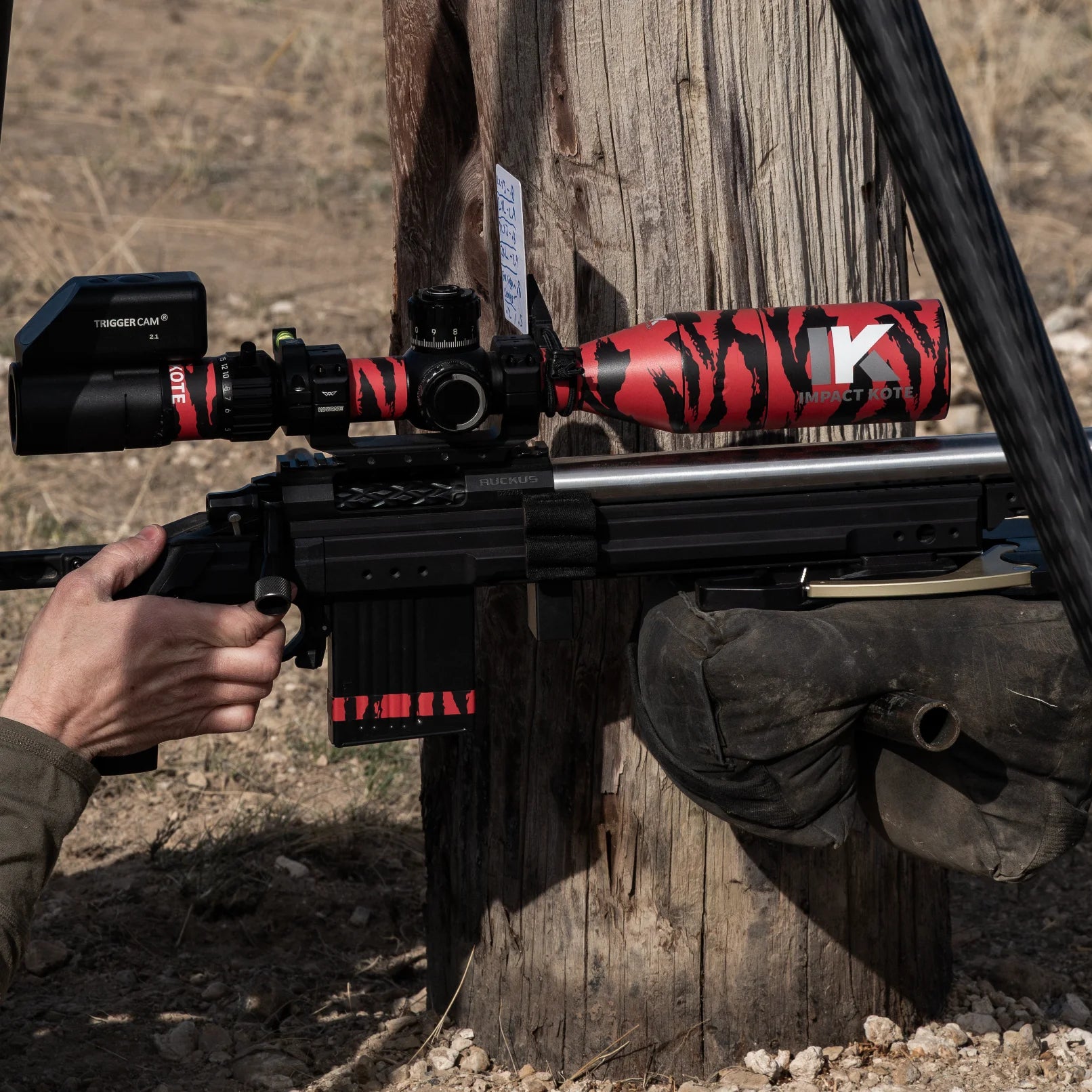 Impact Kote red tigerstripe scope wrap on precision rifle at competition